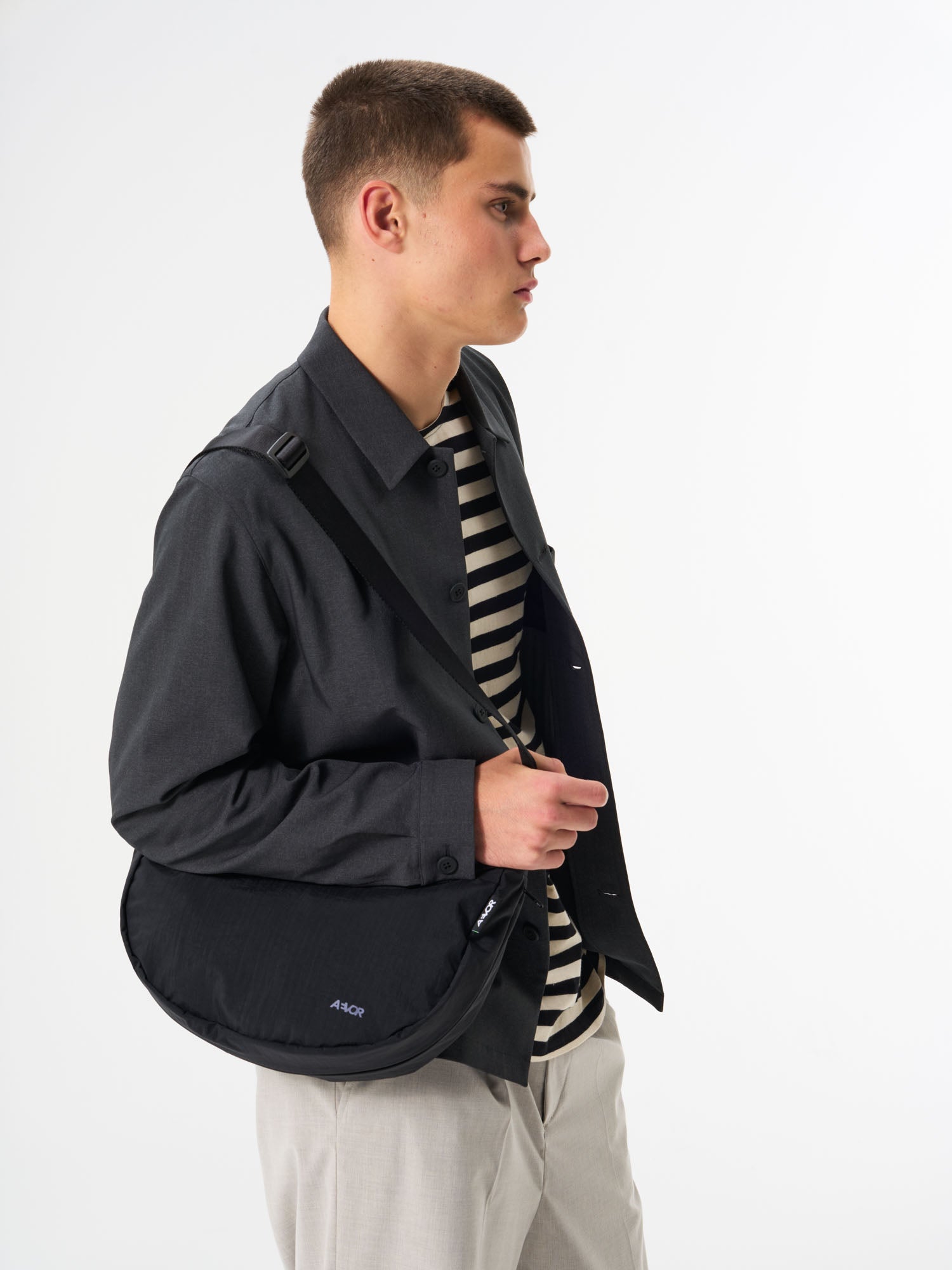 AEVOR-Bike-Sling-Bag-Black-model-front