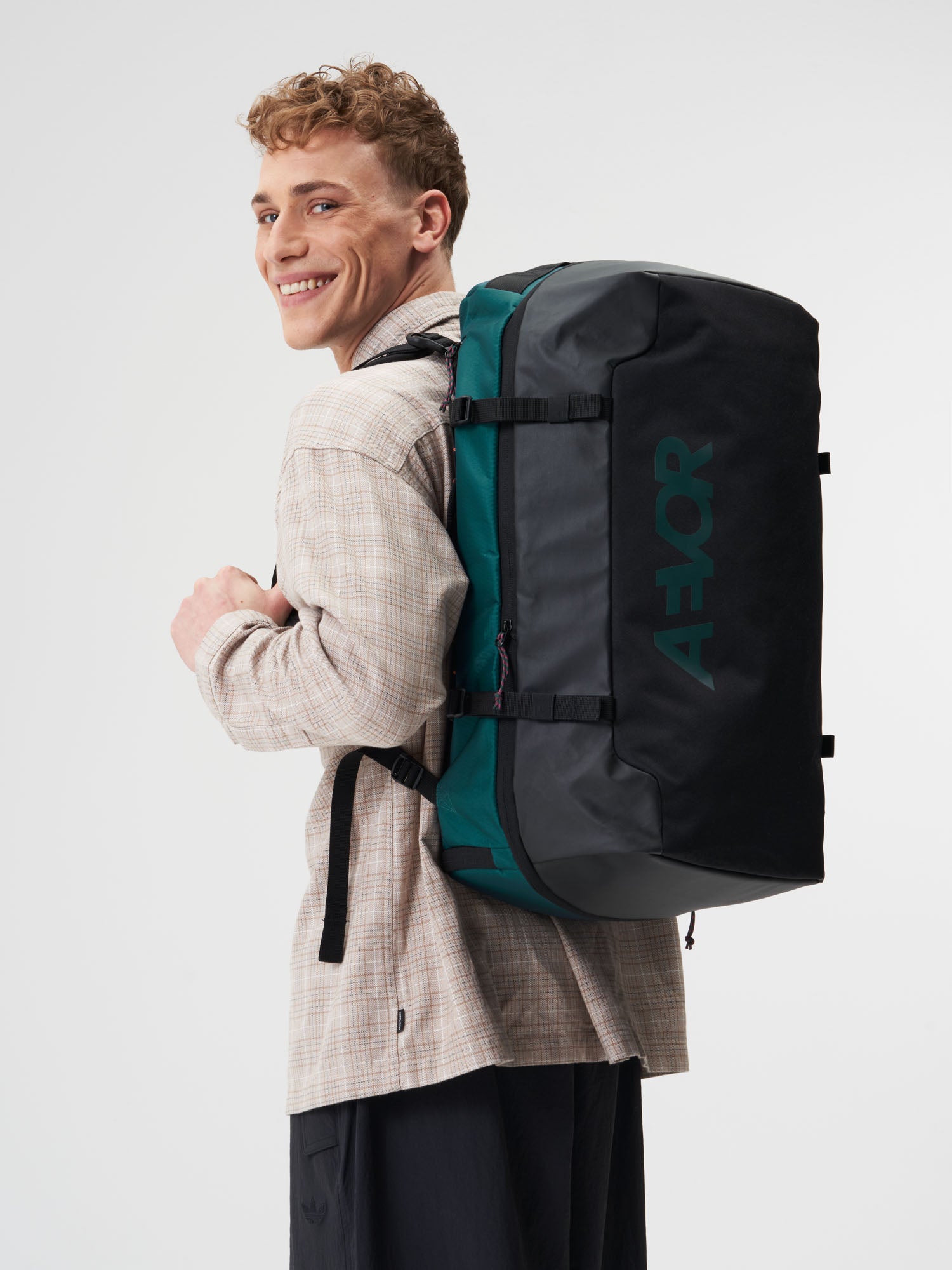 AEVOR-Duffel-Pack-Proof-Evergreen-model-male-side