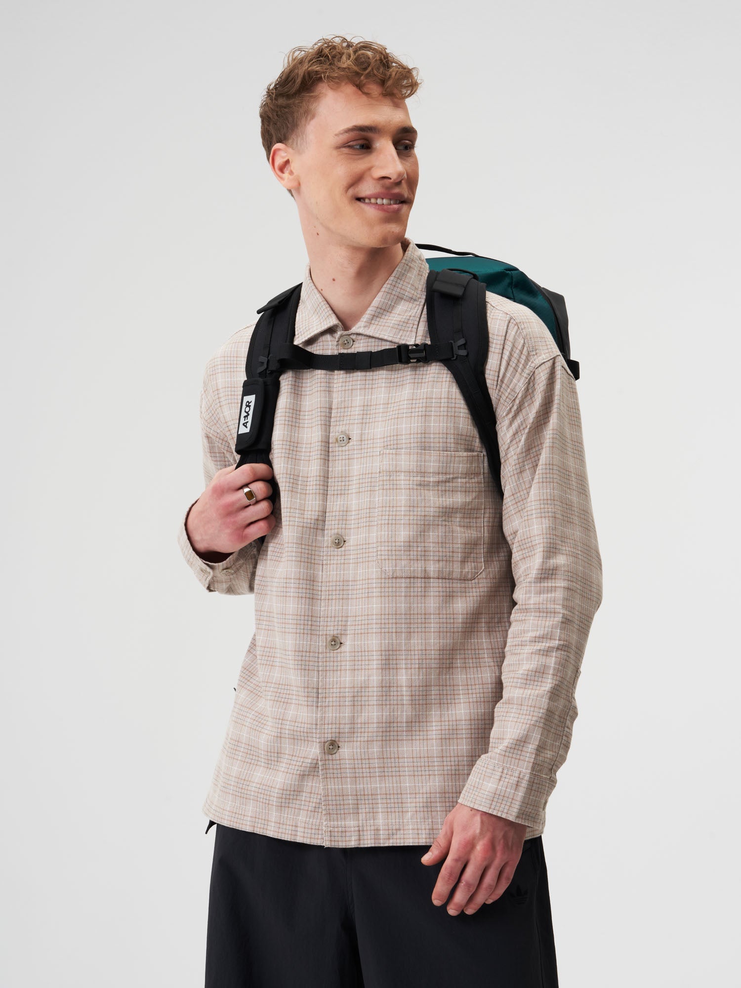 AEVOR-Duffel-Pack-Proof-Evergreen-model-male-back