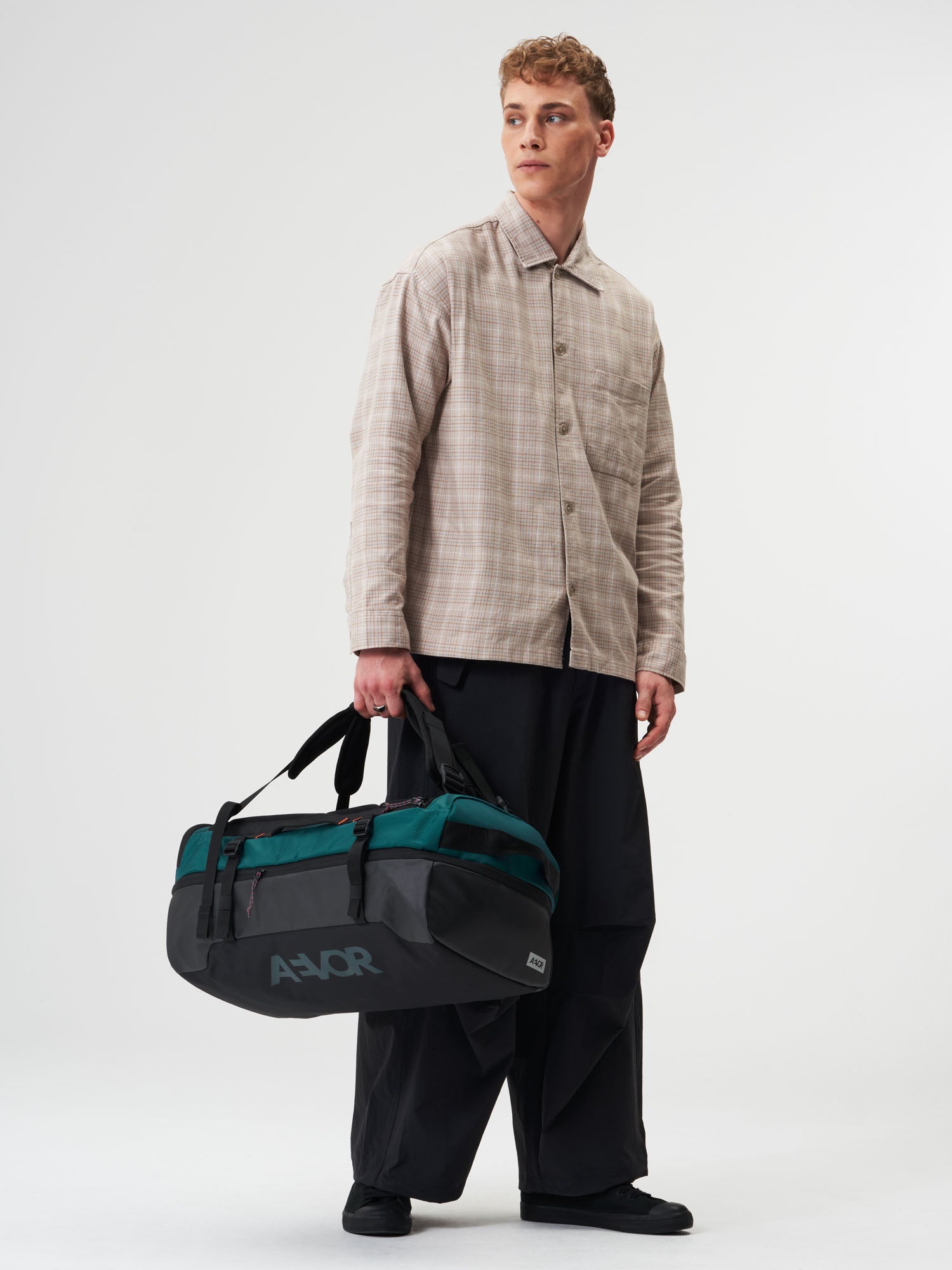 AEVOR-Duffel-Pack-Proof-Evergreen-model-male-front