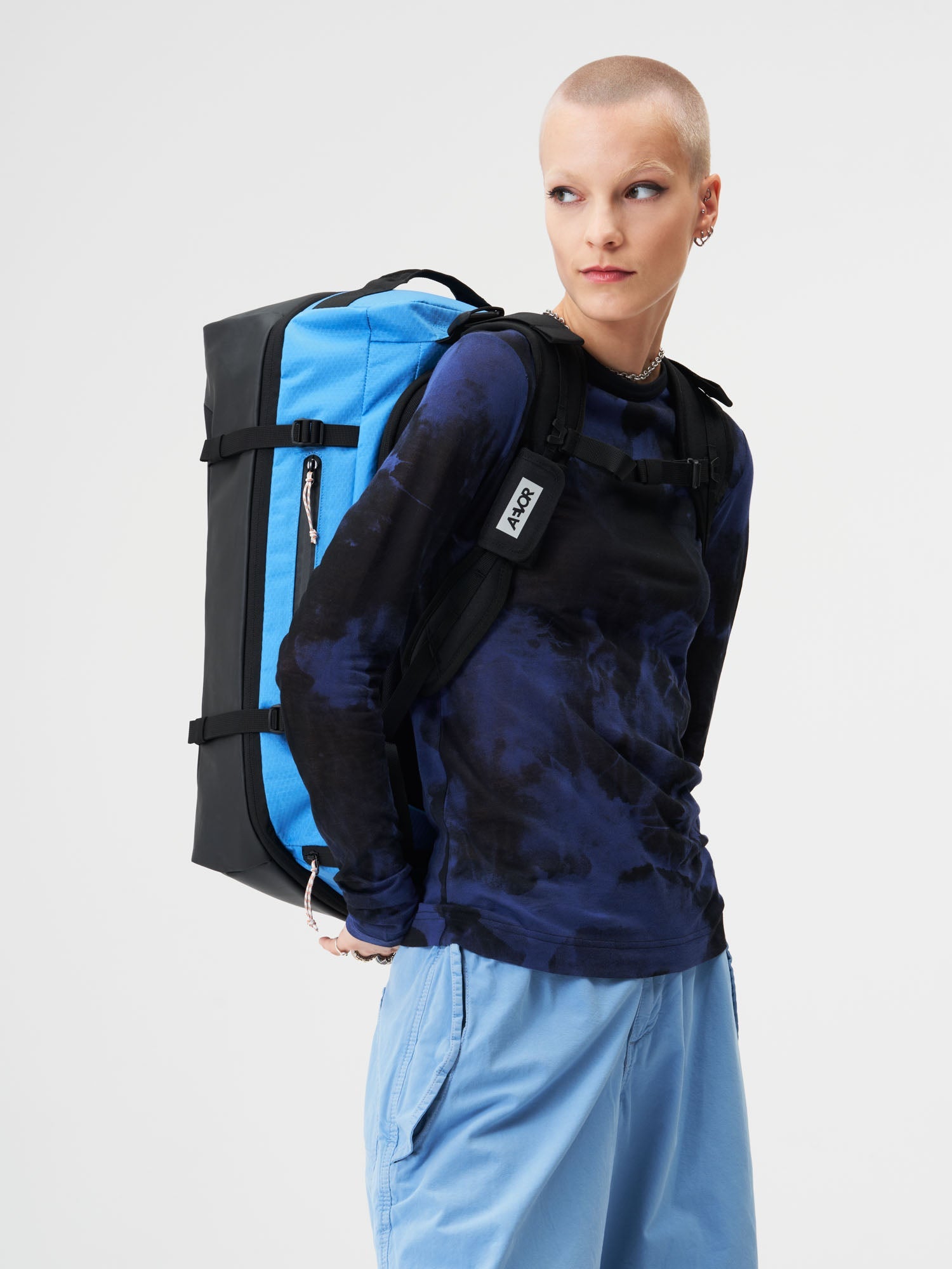 AEVOR-Duffel-Pack-Proof-Retro-Blue-model-female-side
