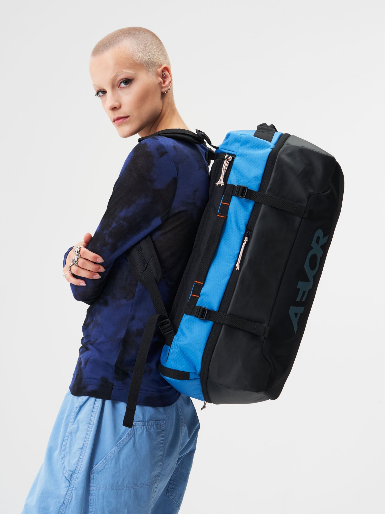 AEVOR-Duffel-Pack-Proof-Retro-Blue-model-female-side