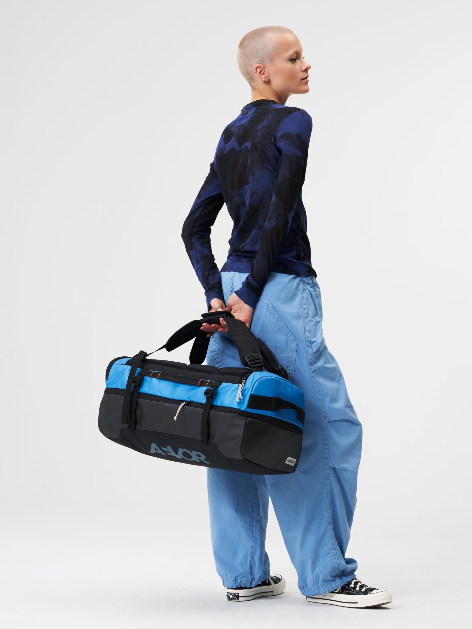 AEVOR-Duffel-Pack-Proof-Retro-Blue-model-female-front