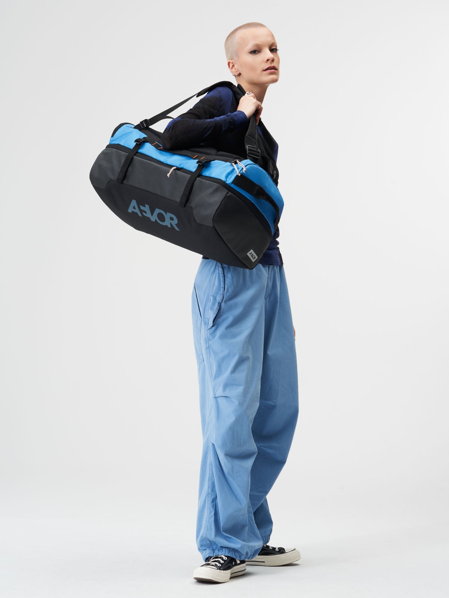 AEVOR-Duffel-Pack-Proof-Retro-Blue-model-female-front