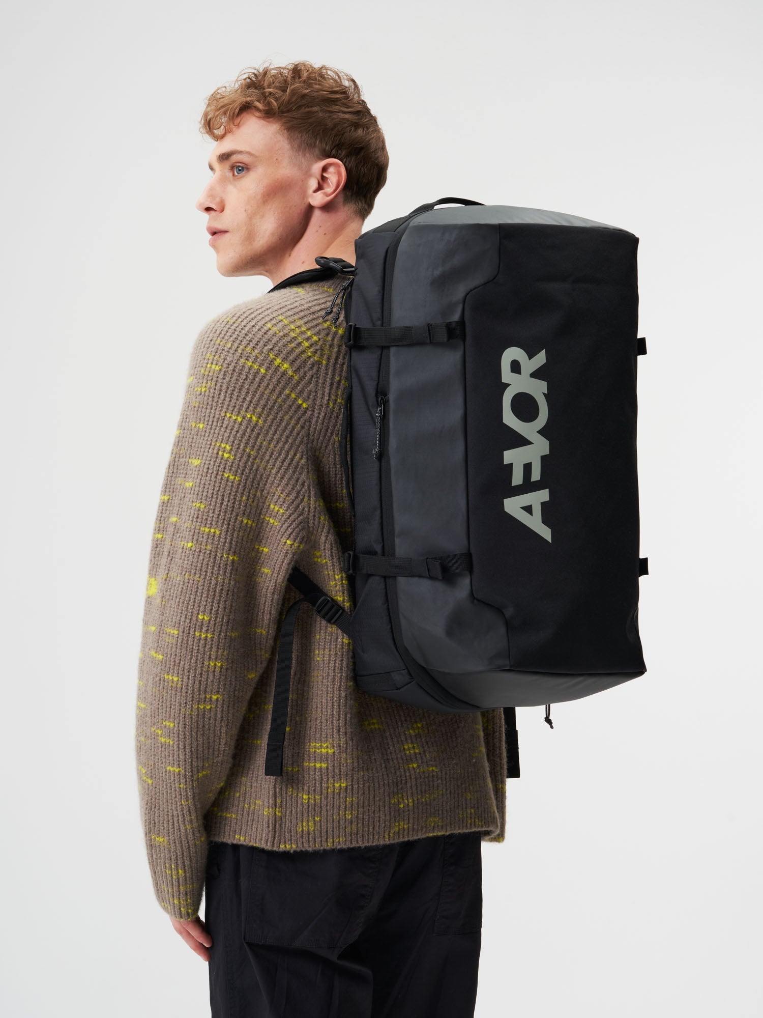 AEVOR-Duffel-Pack-Proof-Black-model-male-front