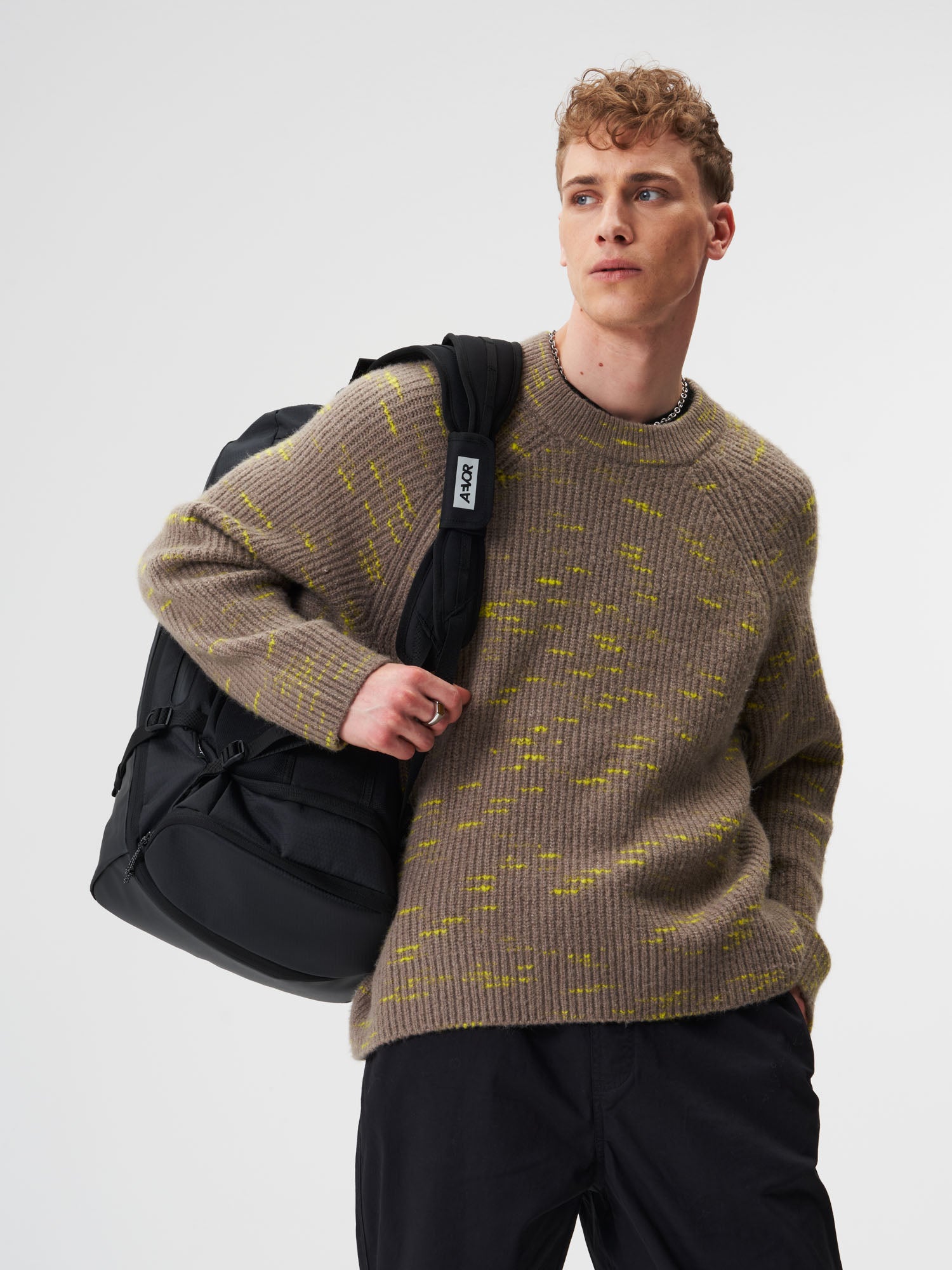 AEVOR-Duffel-Pack-Proof-Black-model-male-side