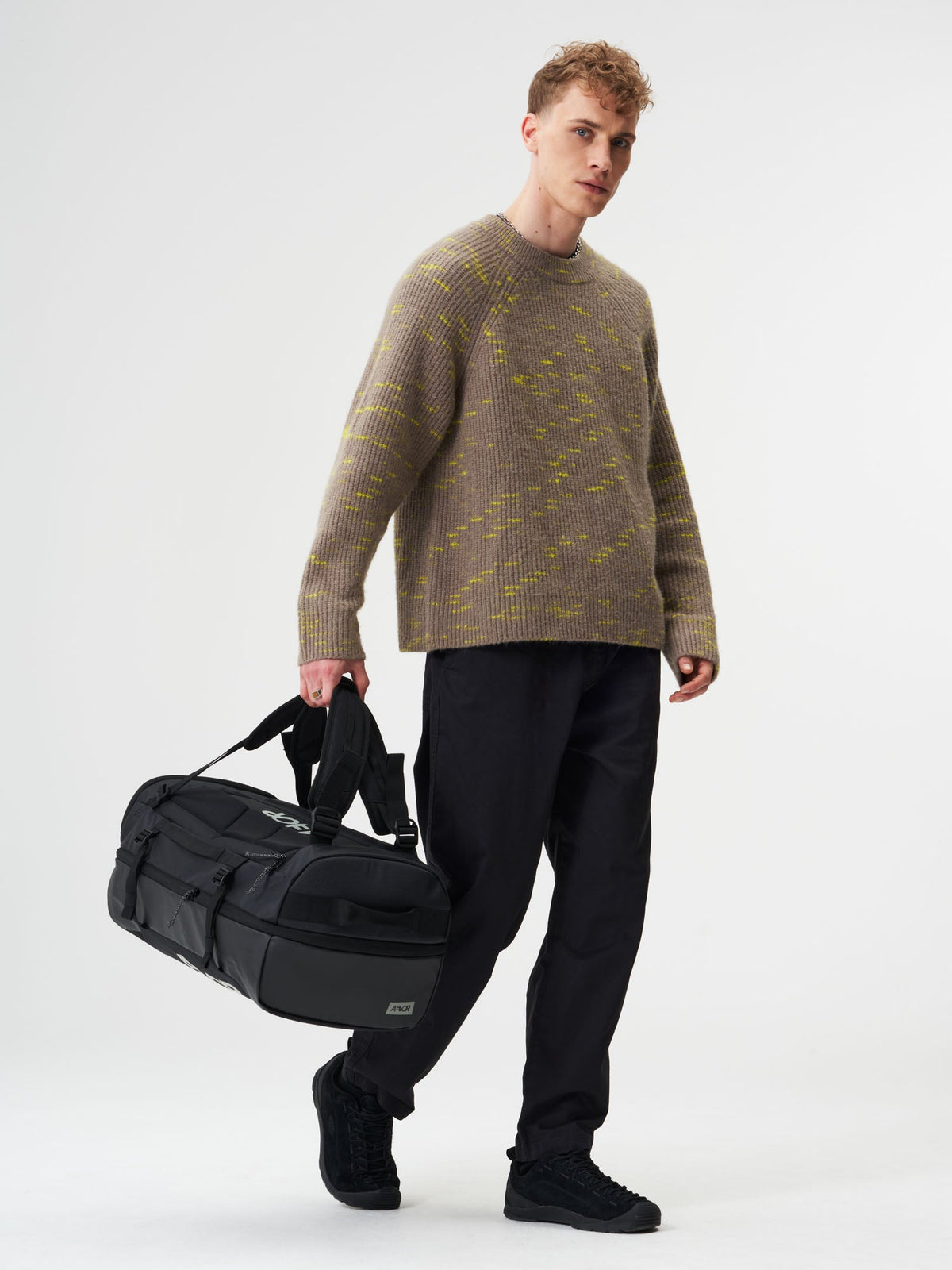 AEVOR-Duffel-Pack-Proof-Black-model-male-front