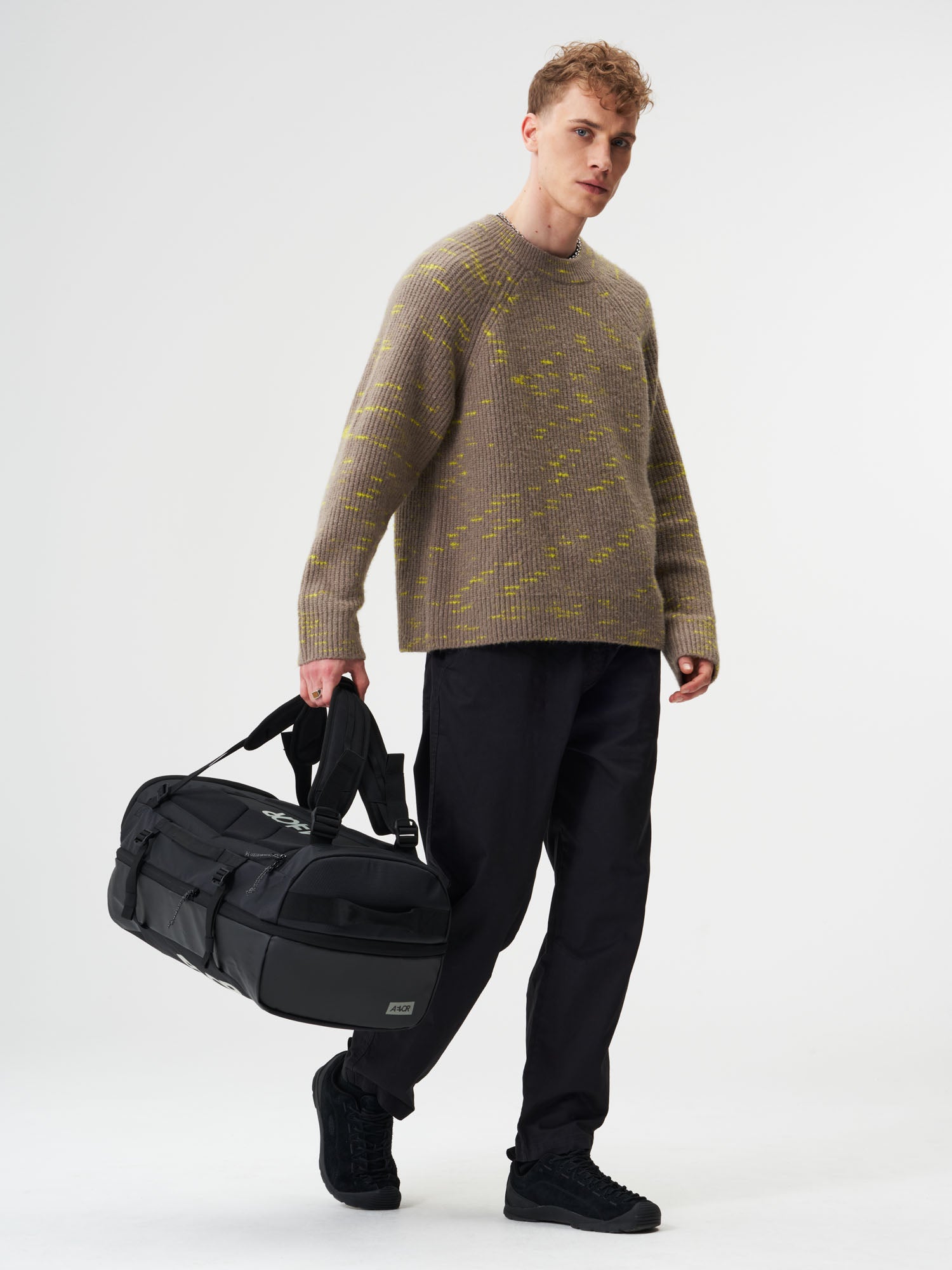 AEVOR-Duffel-Pack-Proof-Black-model-male-front