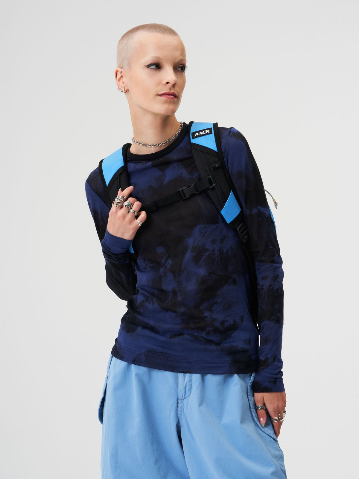 AEVOR-Roll-Pack-Proof-Retro-Blue-model-female-back