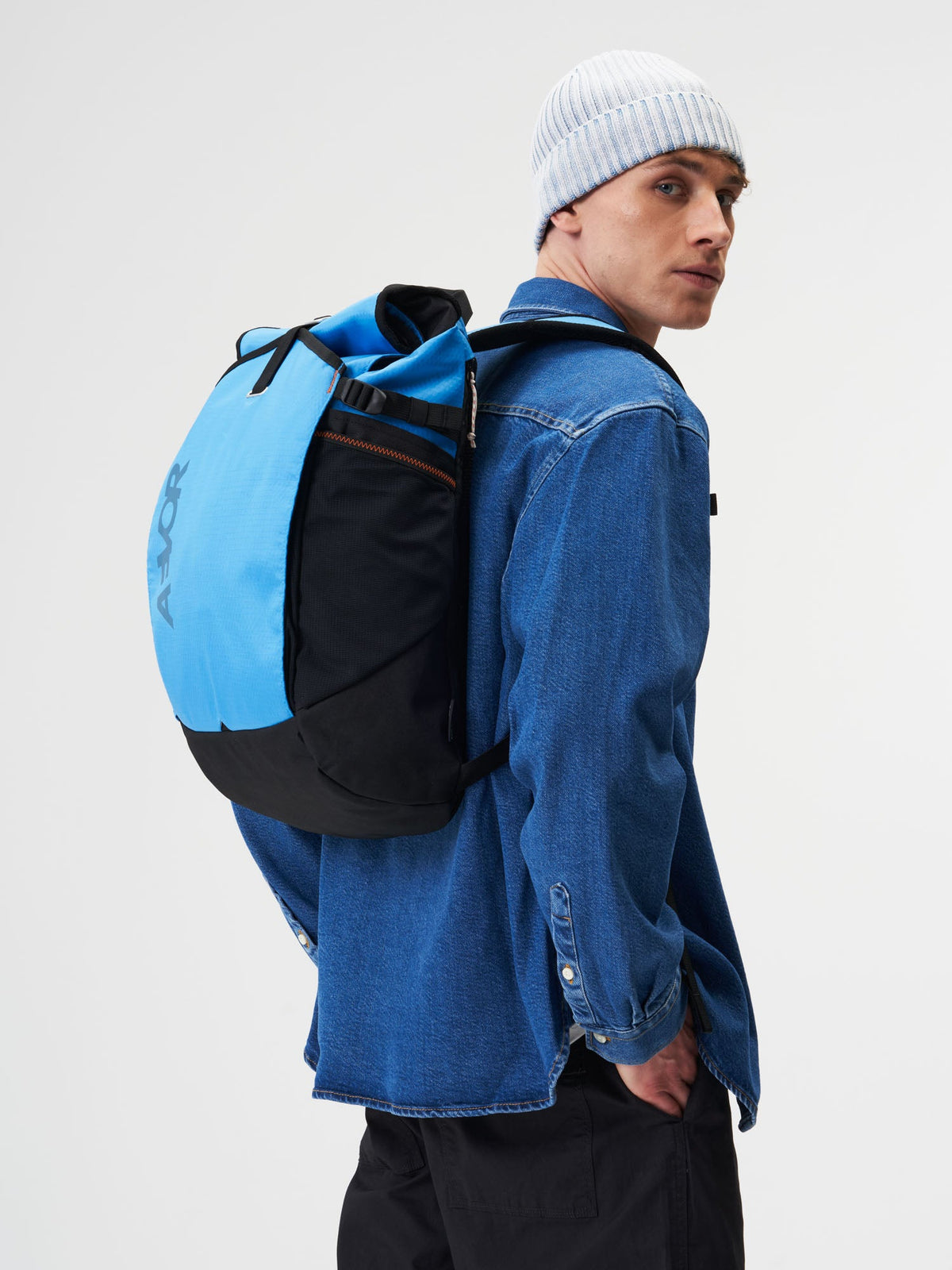 AEVOR-Roll-Pack-Proof-Retro-Blue-model-male-side