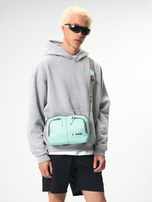 AEVOR-Sacoche-Bag-Proof-Green-Blue-model-male-front