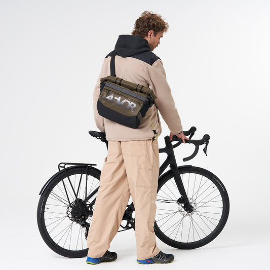 AEVOR-Triple-Bike-Bag-Proof-Olive-Gold-model-front