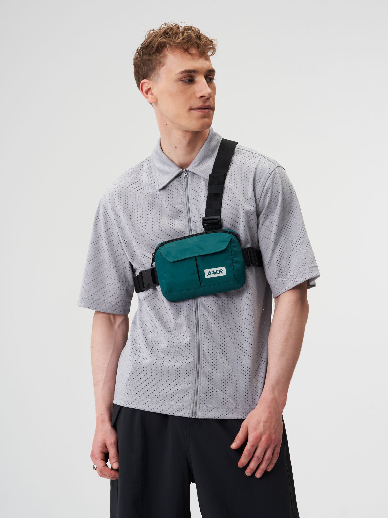 AEVOR-Front-Pack-Ripstop-Evergreen-model-male-front