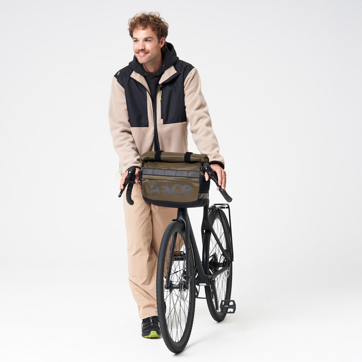 AEVOR-Triple-Bike-Bag-Proof-Olive-Gold-model-front