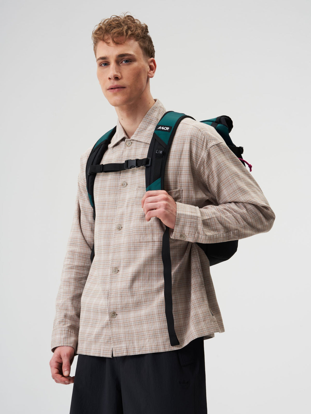 AEVOR-Roll-Pack-Proof-Evergreen-model-male-back