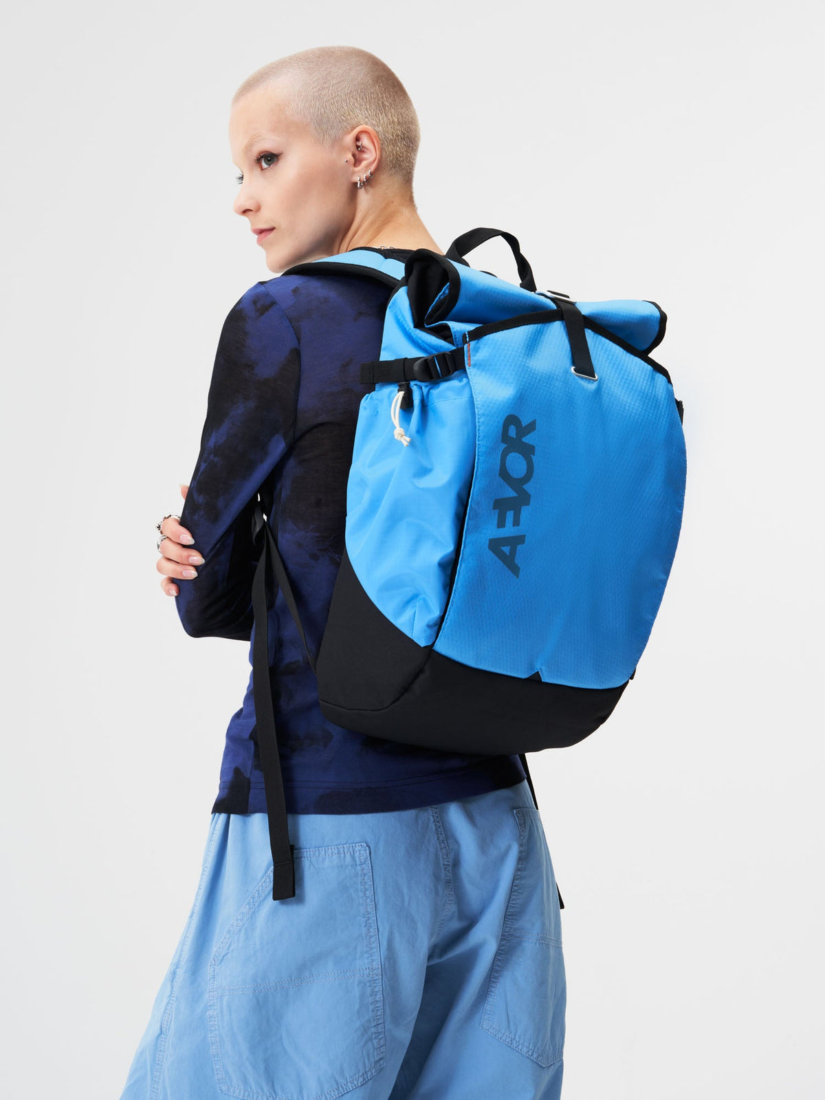 AEVOR-Roll-Pack-Proof-Retro-Blue-model-female-front