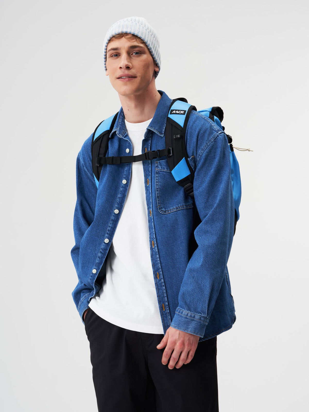 AEVOR-Roll-Pack-Proof-Retro-Blue-model-male-back