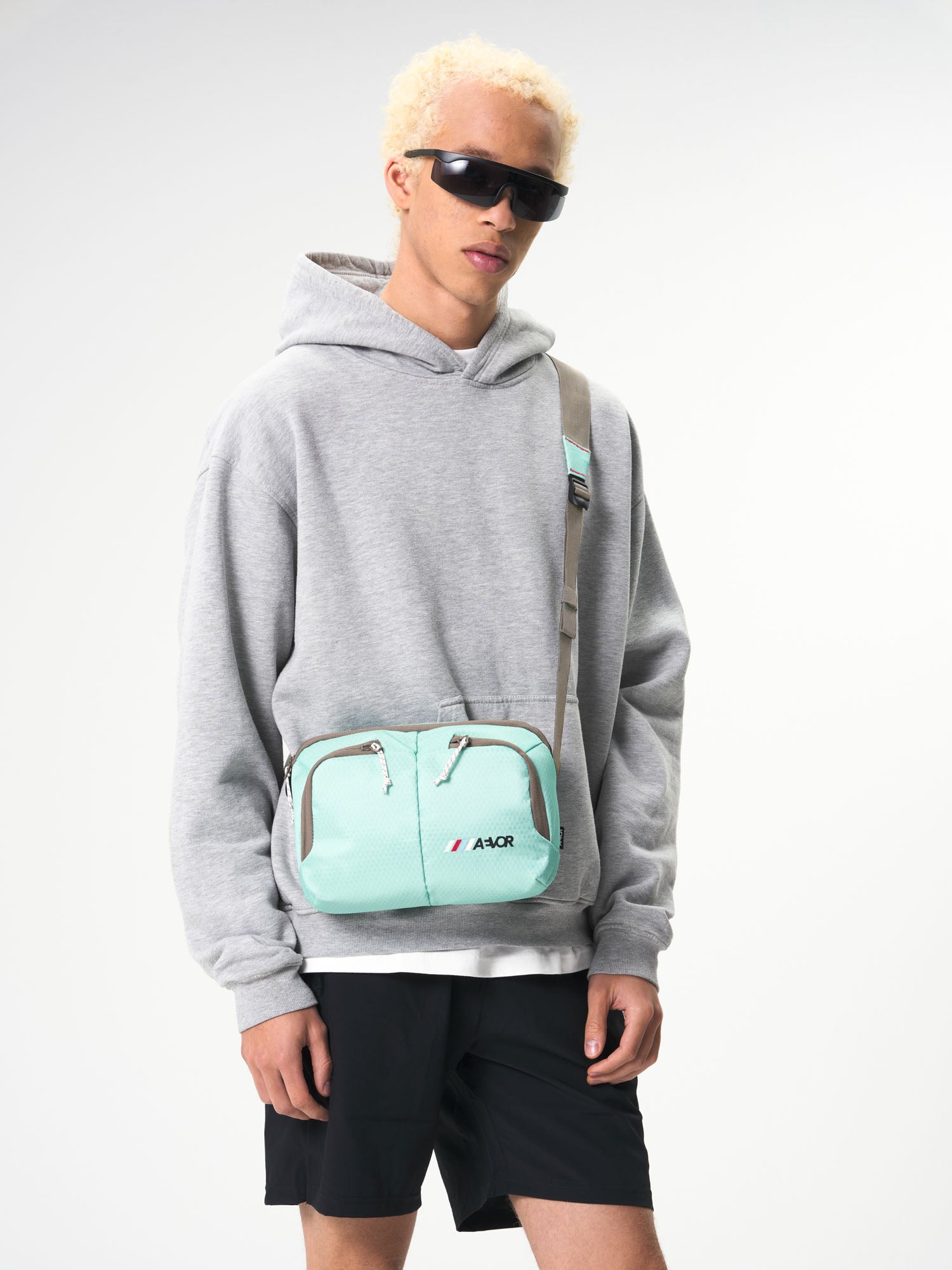 AEVOR-Sacoche-Bag-Proof-Green-Blue-model-male-front