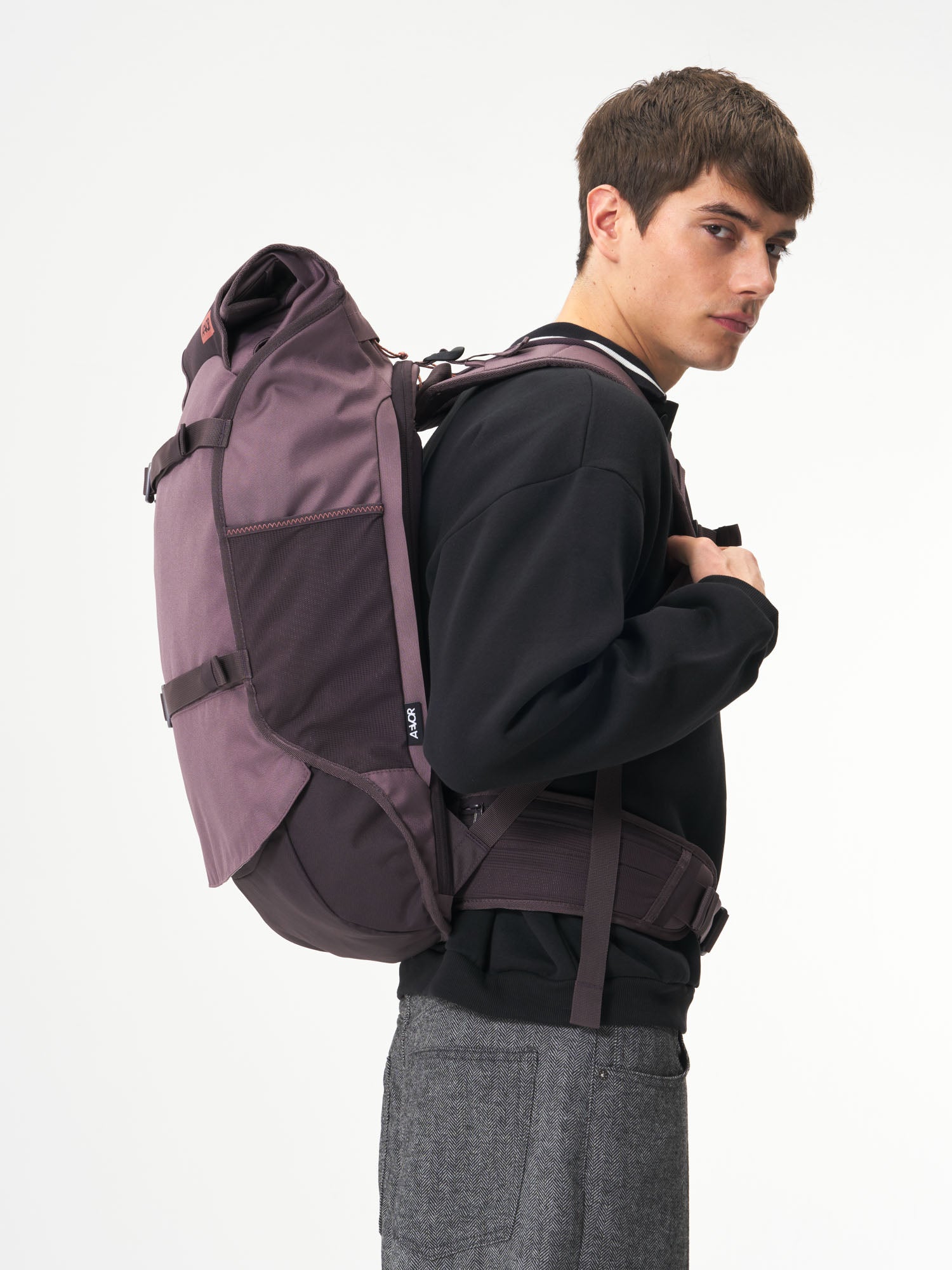 AEVOR-Travel-Pack-Oxy-Purple-model-male-side