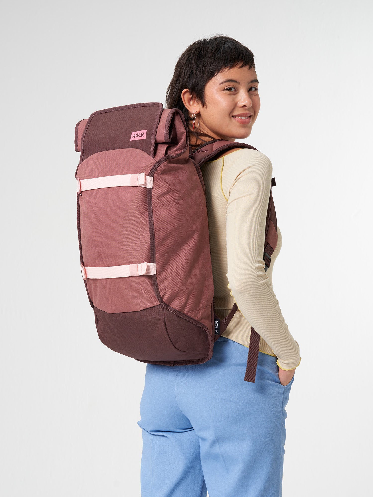 AEVOR-Trip-Pack-Raw-Ruby-model-front
