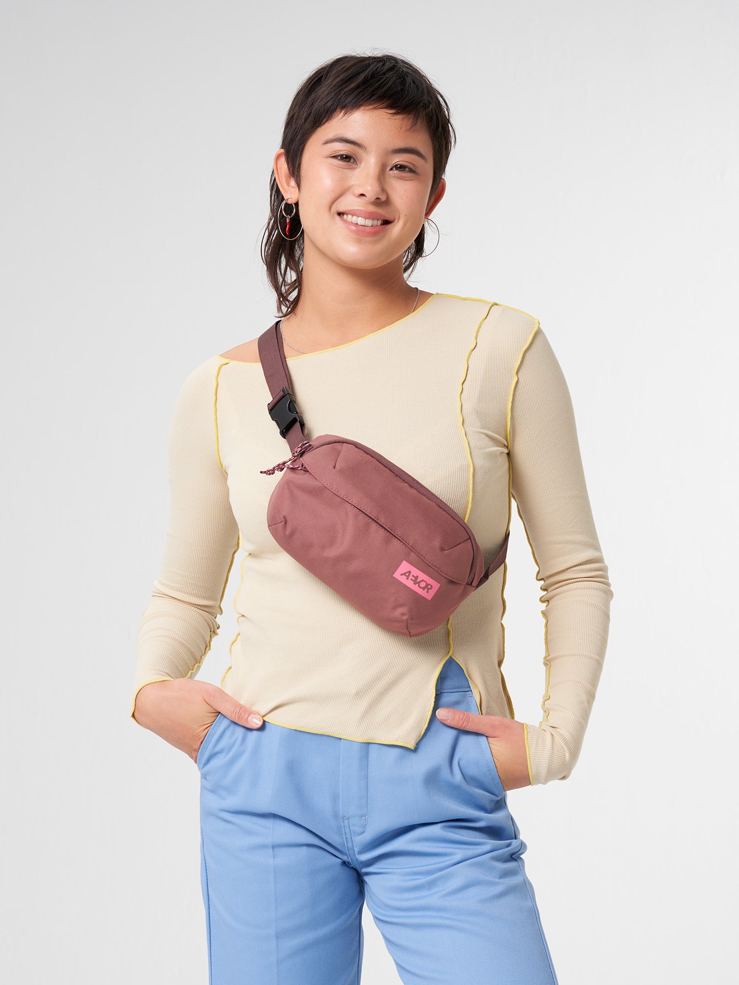 AEVOR-Hip-Bag-Ease-Raw-Ruby-model-front