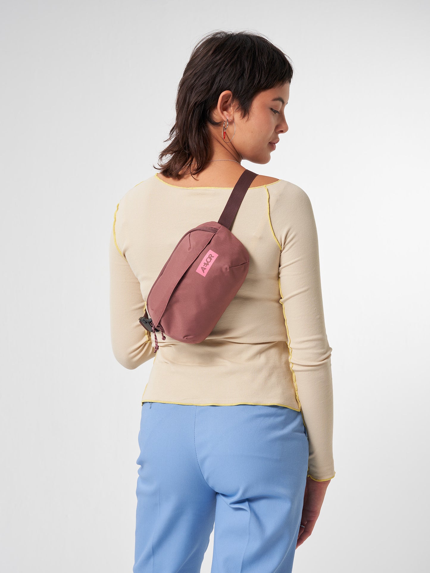 AEVOR-Hip-Bag-Ease-Raw-Ruby-model-front